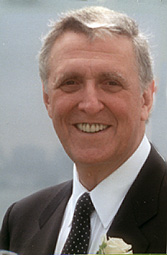Warren Mitofsky, a late-middle aged man with light skin and gray hair, wearing a suit and tie.