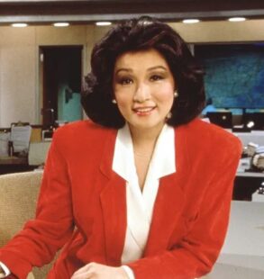 Connie Chung sits in a news room