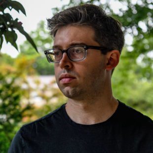 Man in glasses gazing into the distance