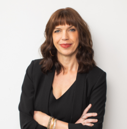 photo of Sara Archambault, a light-skinned woman with brown hair, wearing a black blazer and shirt.