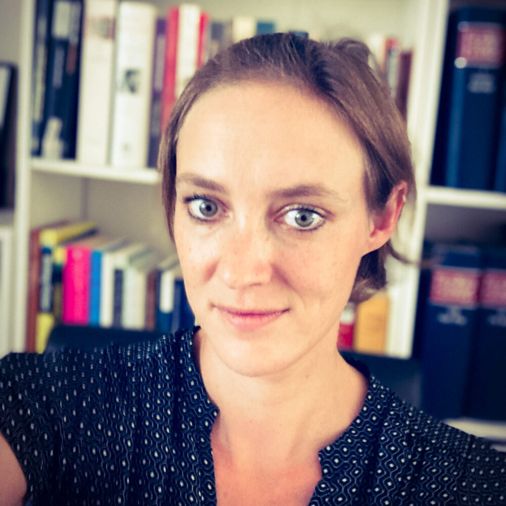 photo of Viktoria Gabriel, a light-skinned woman with brown hair, wearing a blue shirt