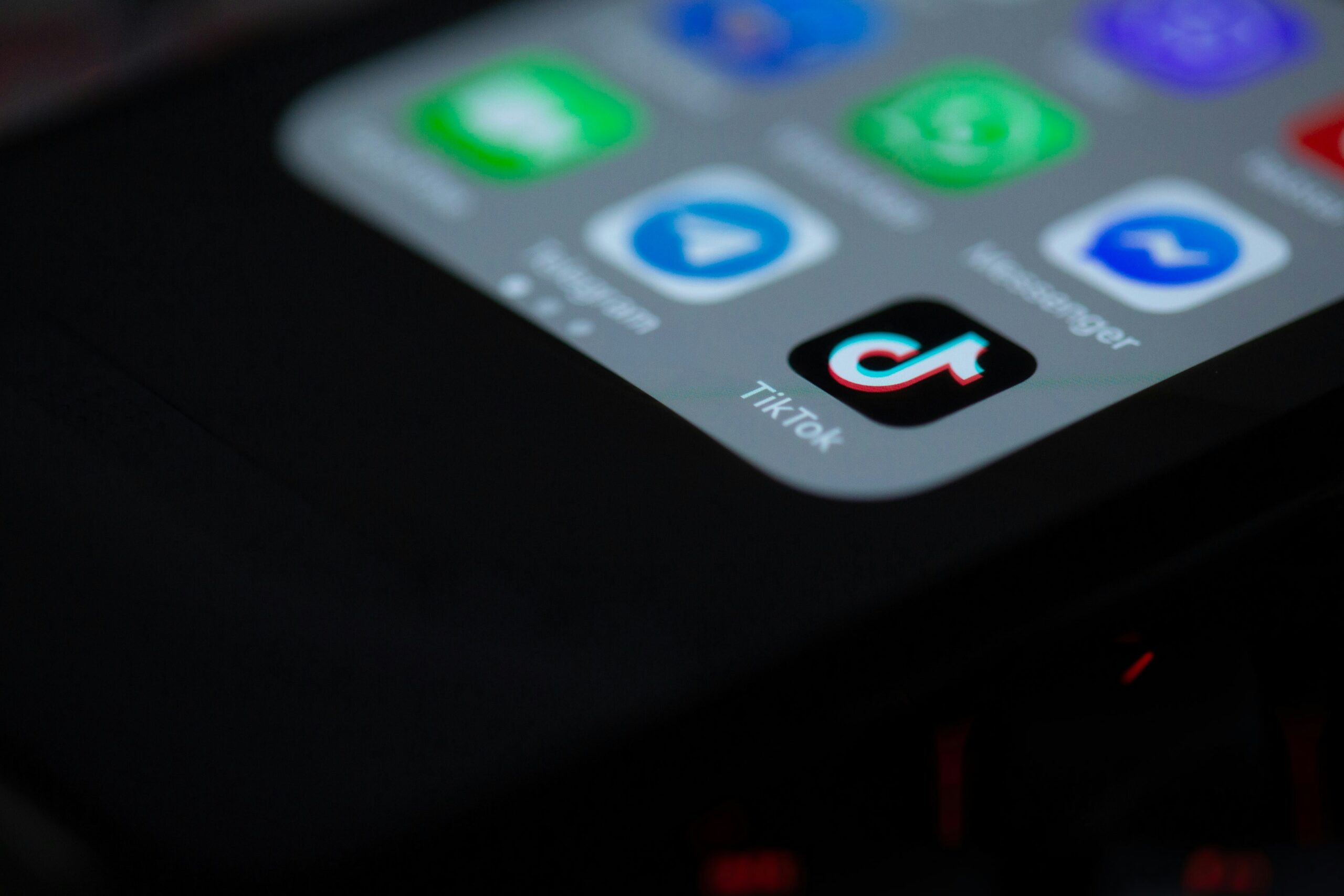 photo of a cell phone showing the TikTok app logo. Photo by Solen Feyissa on Unsplash