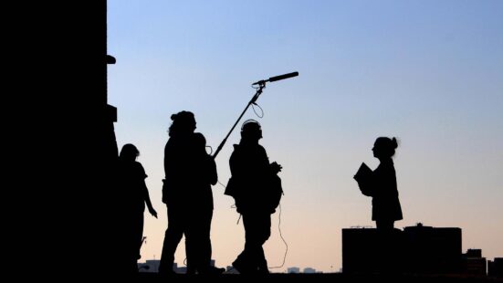 Photograph of silhouettes of film crew