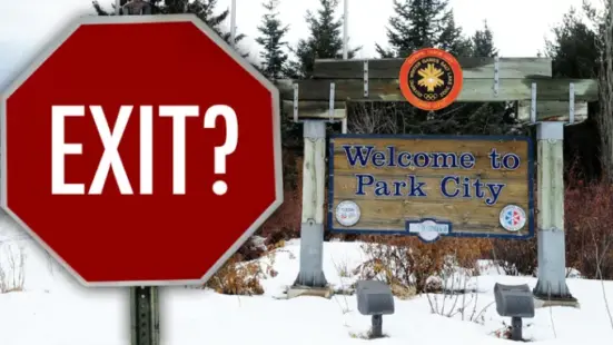 Image of a stop sign with the message "Exit?" on it, next to a "Welcome to Park City" sign