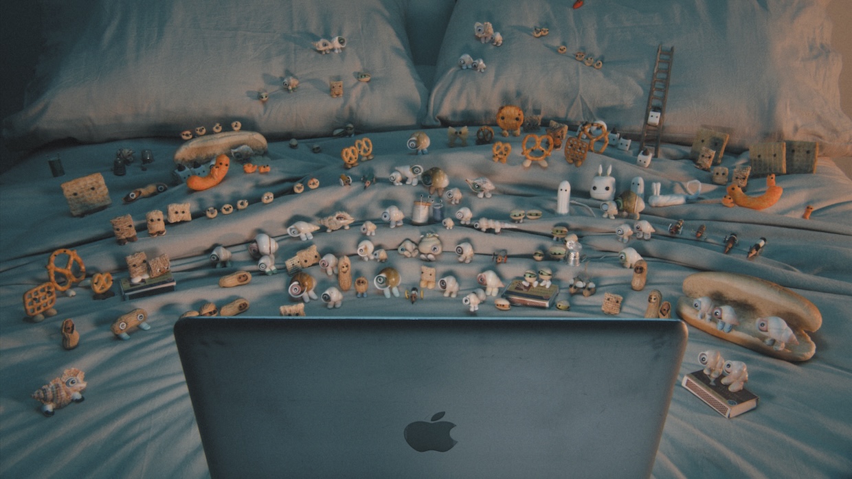 A still from "Marcel the Shell with Shoes On," featuring a number of animated characters behind a laptop
