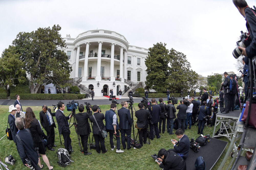 reporters line up outside of the White House with cameras. Photo by Ben Solomon/U.S. Department of State. In the public domain via Creative Commons https://www.flickr.com/photos/127744844@N06/25568250763