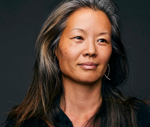 Karen Chien, a woman of Asian descent with long dark hair streaked with gray and gold