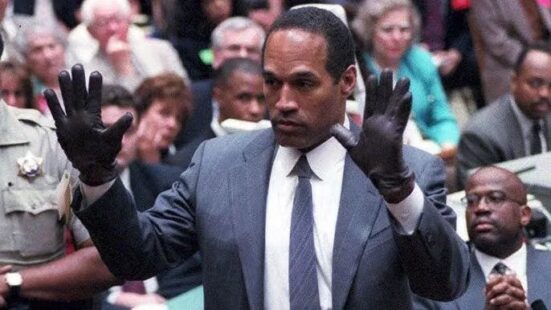 Man in suit with hands held up