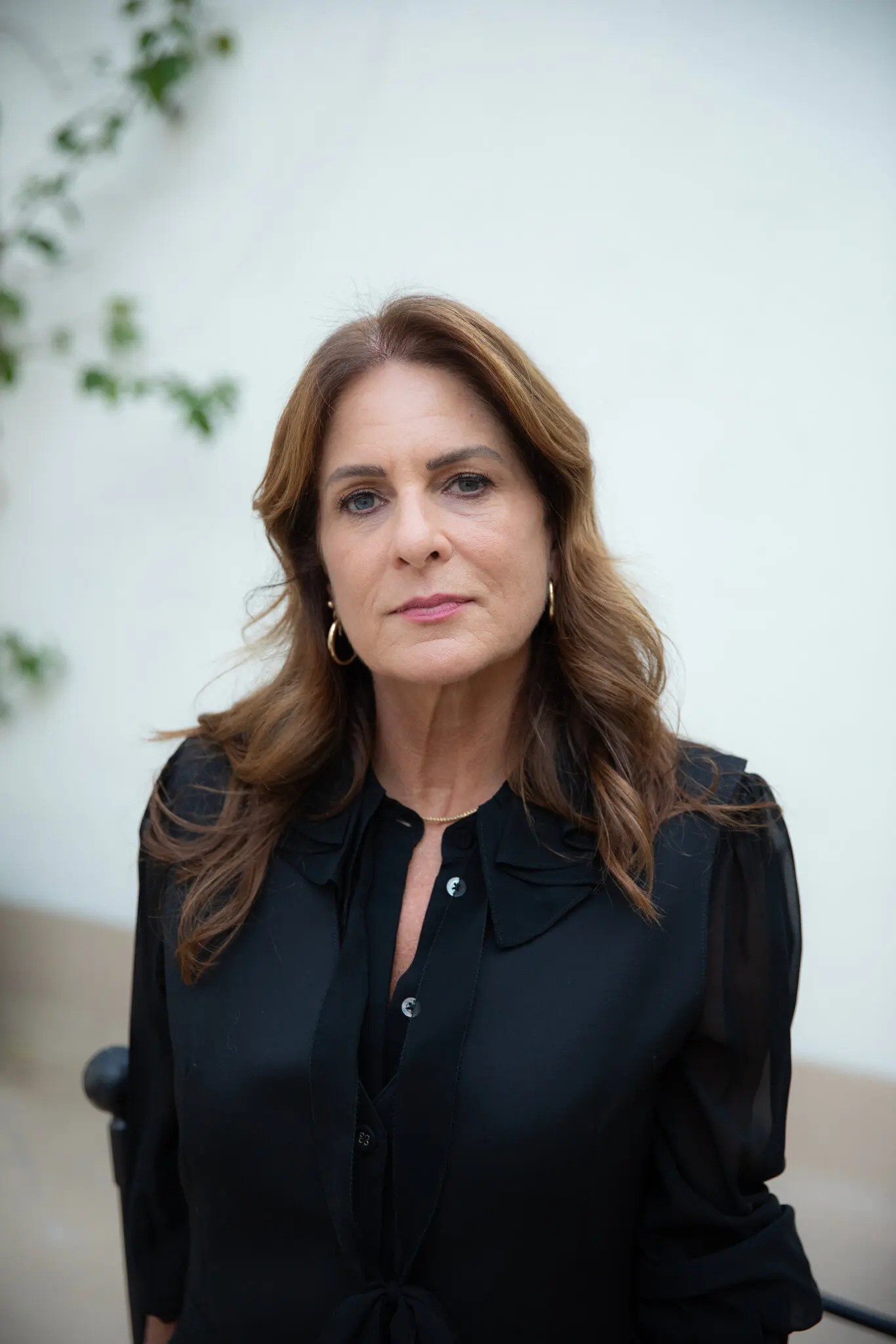 Woman in a black top gazing into the camera