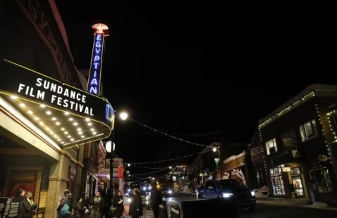 Evening sky featuring a movie theatre lit up with the text Sundance Film Festival