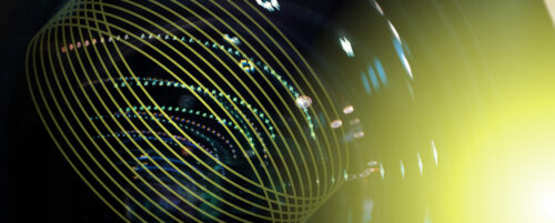 image of a camera lens with a yellow flare overlay