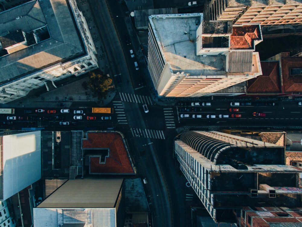 photograph of an intersection in a city with tall buildings, taken from above.