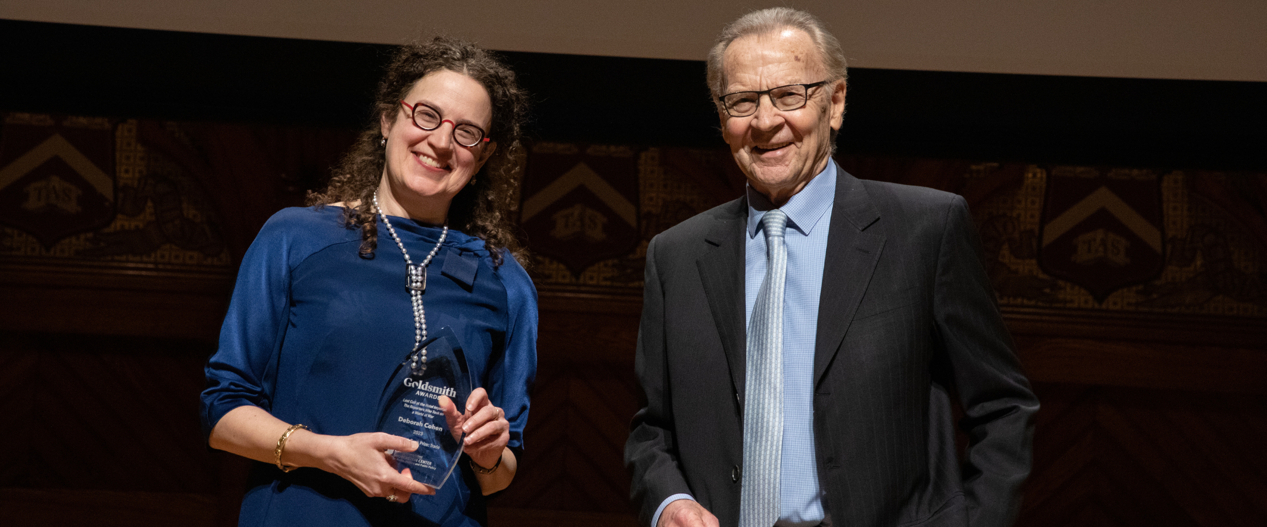 Goldsmith Book Prize Winner Deborah Cohen stands on stage with Professor Thomas Patterson.