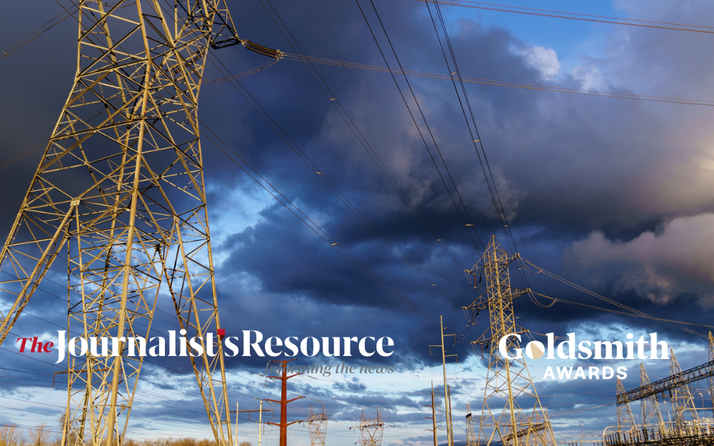 High-voltage power transmission towers and electrical lines under dark storm clouds, with logos for The Journalist’s Resource and the Goldsmith Awards overlaid on the image.